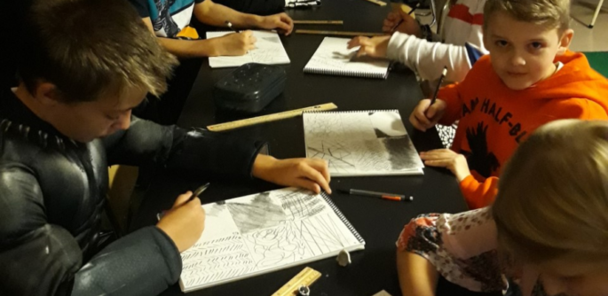 A table full of students sketching.